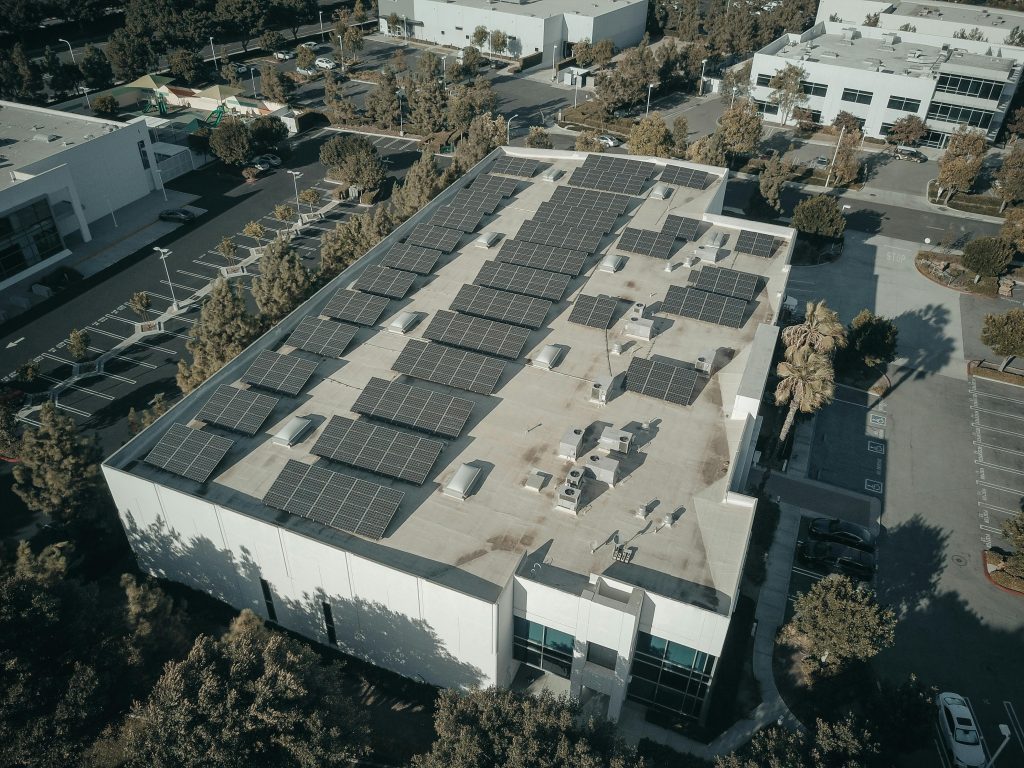 Aerial view of a building with solar panels on the roof, harnessing solar energy for sustainable power generation.